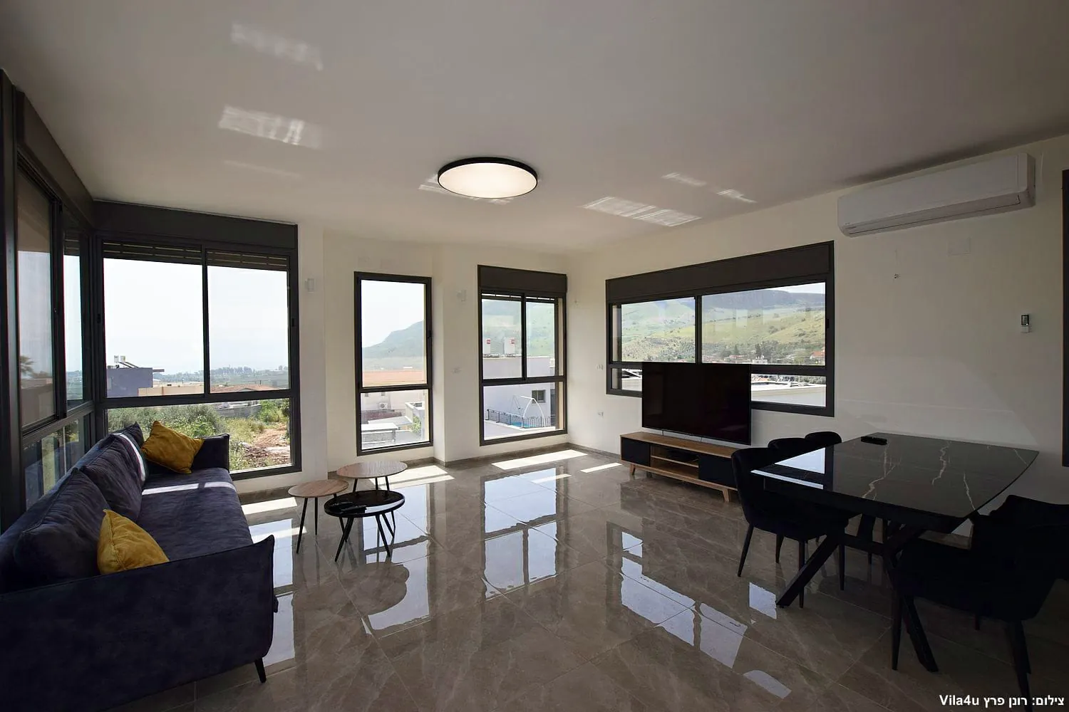 Kinneret House – living room with TV and dining area