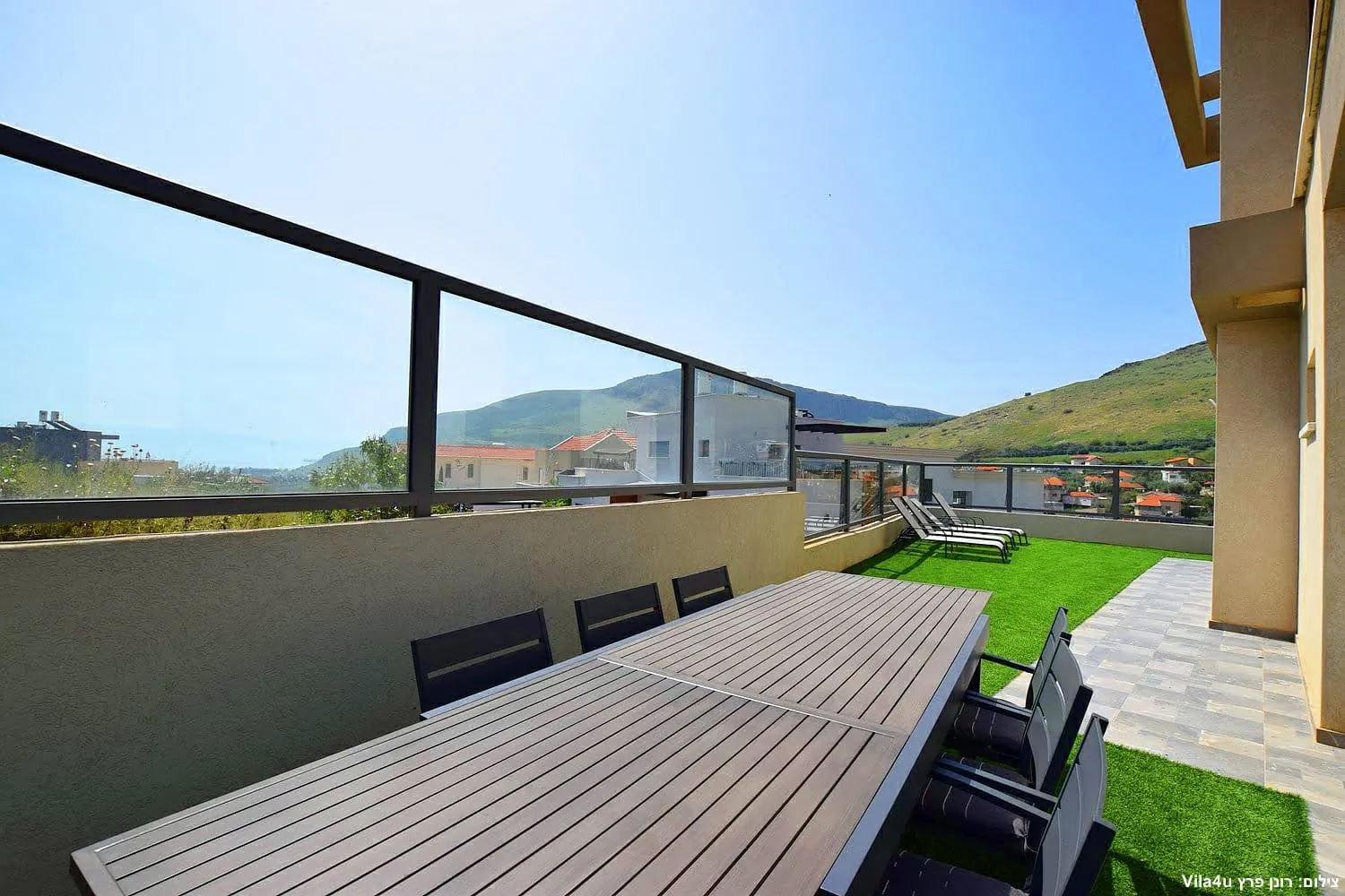 Kinneret House – long outdoor dining table with Arbel view